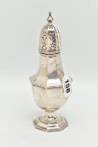 A GEORGE V SILVER SUGAR CASTER, faceted form, pierced cover with pointed finial, on a weighted base,
