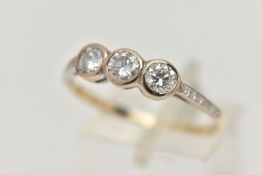 A THREE STONE DIAMOND RING, three round brilliant cut diamonds bezel set in white metal, approximate