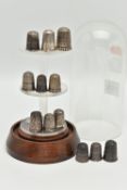 TWELVE 'CHARLES HORNER' SILVER THIMBLES AND A DOMED GLASS DISPLAY CASE, all hallmarked 'Charles