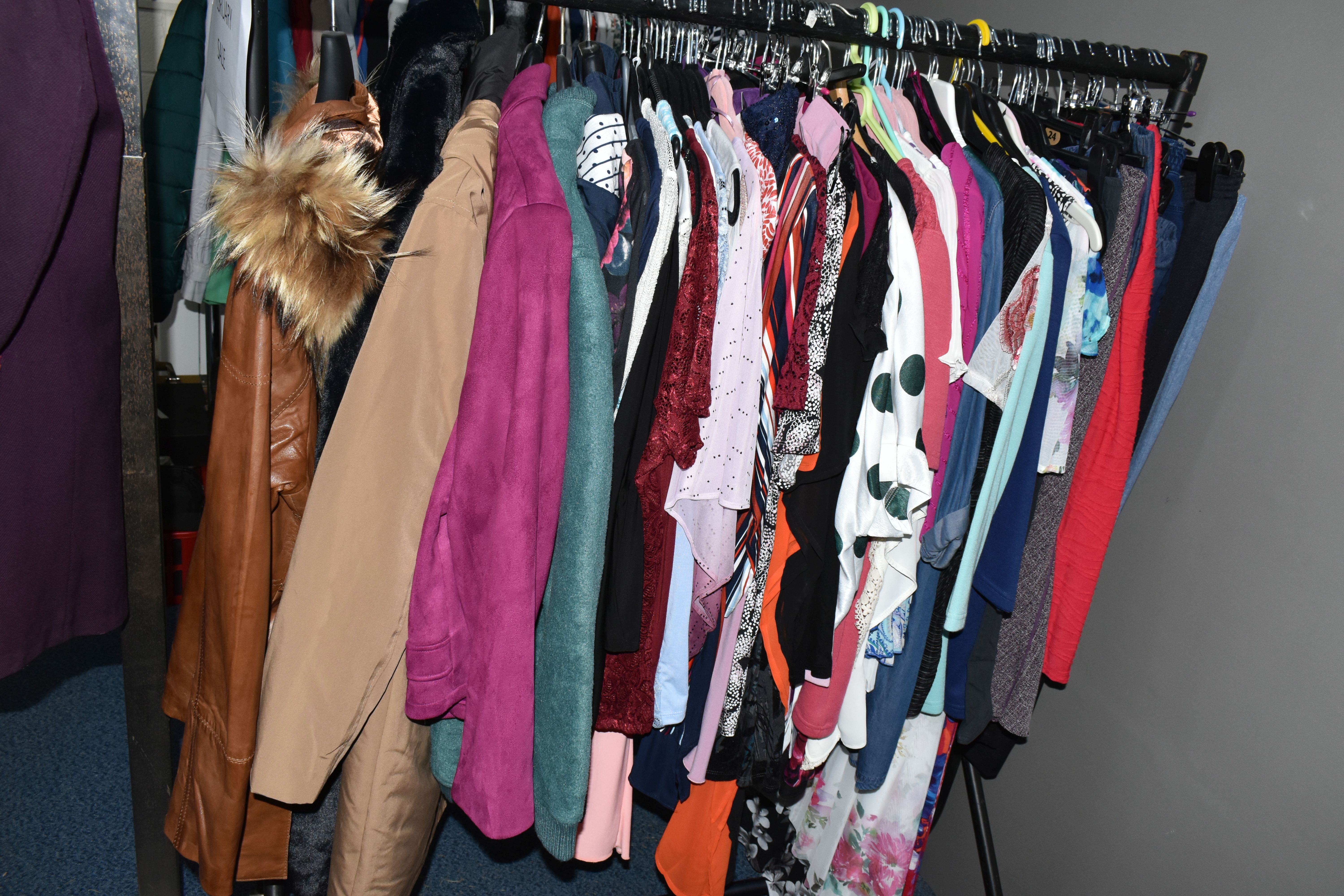 A QUANTITY OF MODERN UNUSED LADIES' CLOTHING, to include a brown leather jacket, black faux fur, - Image 2 of 27