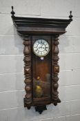 A GUSTAV BECKER REGULATOR WALL CLOCK, the later loose cornice with twin finials, the arched glazed