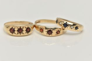 THREE 9CT GOLD GEM SET RINGS, the first a gents three stone garnet ring with star setting detail,