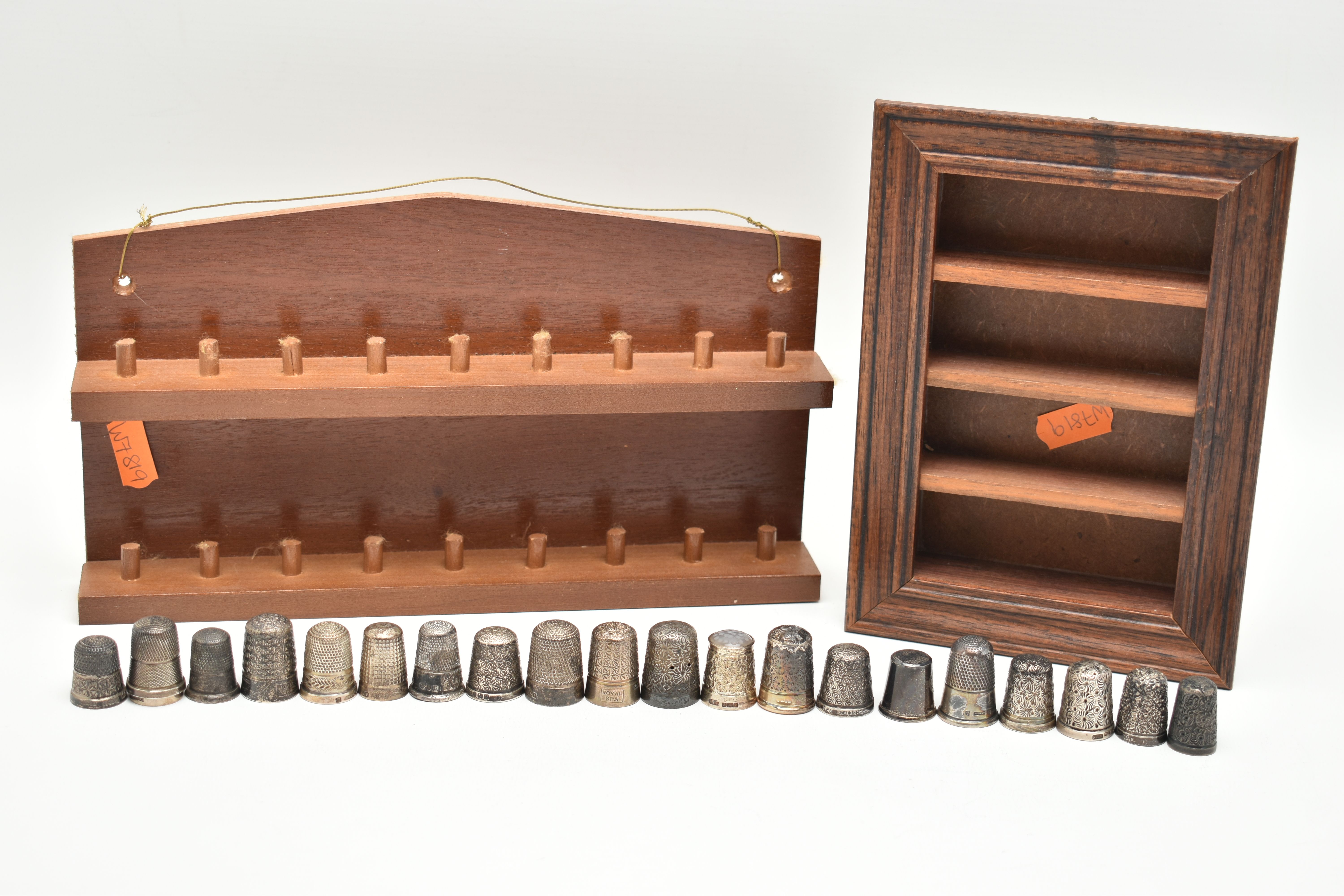 A SELECTION OF SILVER THIMBLES AND TWO DISPLAY SHELVES, to include twenty-one thimbles, various