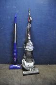 A DYSON DC25 UPRIGHT VACUUM CLEANER (brushbar not working) and a Bissell Feather Weight stick vacuum