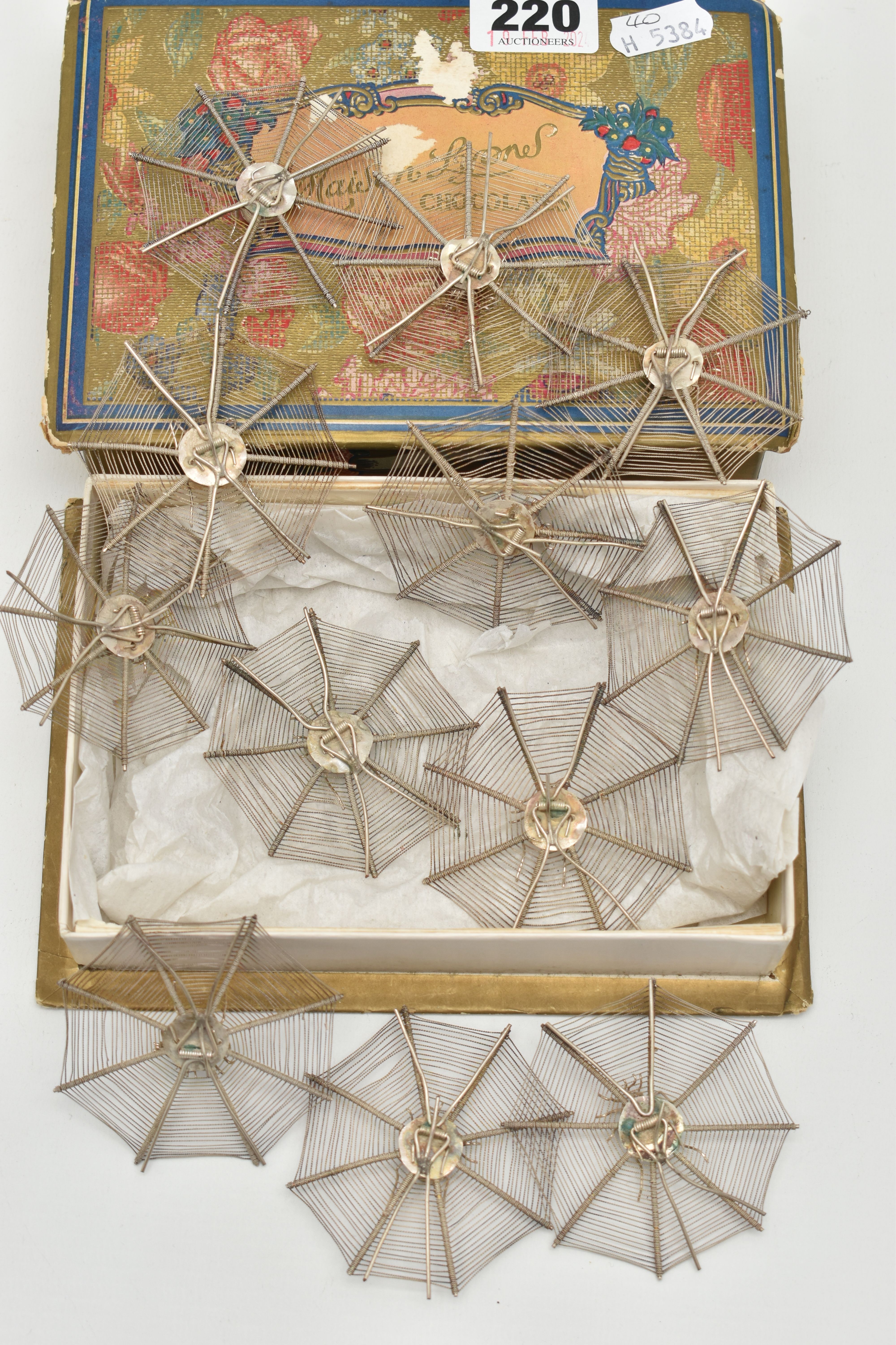 A SET OF TWELVE NOVELTY WHITE METAL OCTAGONAL FILIGREE EASEL BACK PLACE NAME HOLDERS IN THE FORM - Image 4 of 5