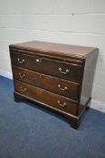 A GEORGIAN MAHOGANY CHEST OF THREE DRAWERS, with a brushing slide, brass neck handles, on bracket