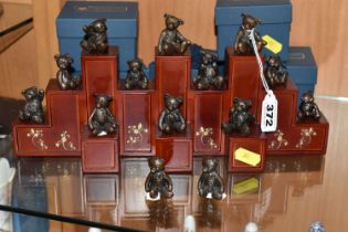 FOURTEEN DANBURY MINT 'LITTLE BRONZE BEARS', one is a duplicate, some boxed, together with a display