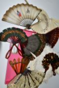 A COLLECTION OF TEN LATE 19TH AND EARLY 20TH CENTURY FANS, comprising a large cream coloured Ostrich