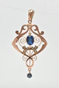 AN EDWARDIAN GEM SET PENDANT, the openwork scrolling design pendant set with a central oval blue