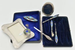 TWO SILVER PHOTO FRAMES AND AN INCOMPLETE MANICURE SET, the first an early 20th century, polished