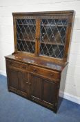 A 20TH CENTURY OAK LEAD GLAZED BOOKCASE, enclosing two fixed shelves, over a base with two drawers