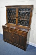 A 20TH CENTURY OAK LEAD GLAZED BOOKCASE, enclosing two fixed shelves, over a base with two drawers