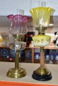 TWO VICTORIAN OIL LAMPS, one has an etched yellow glass shade, moulded yellow milk glass reservoir