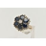 A LARGE 18CT GOLD SAPPHIRE AND DIAMOND CLUSTER RING, six oval cut sapphires and a central round