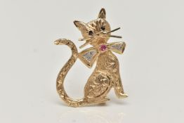 A 9CT GOLD CAT BROOCH, the textured seated cat with a diamond and ruby set bow, 9ct hallmark, length