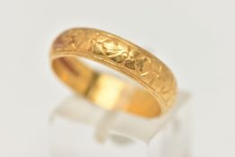 A 22CT YELLOW GOLD WEDDING BAND, the D-shape cross section hand with floral engraved detail,