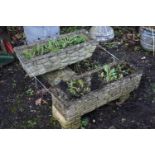 A NEAR PAIR OF WEATHERED COMPOSITE BRICK EFFECT RECTANGULAR PLANTER, one on a pair of stands, the