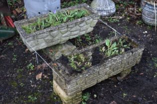 A NEAR PAIR OF WEATHERED COMPOSITE BRICK EFFECT RECTANGULAR PLANTER, one on a pair of stands, the