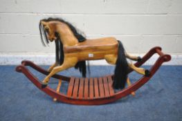 A HANDMADE HARDWOOD ROCKING HORSE, with real horse hair, on a stained bow frame, length 120cm x