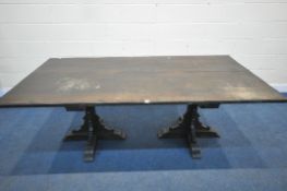 A 20TH CENTURY OAK RECTANGULAR TABLE, with twin ecclesiastical pedestal legs, length 214cm x depth