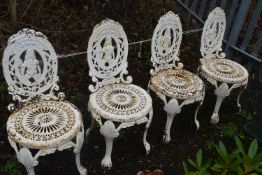 A SET OF FOUR WHITE PAINTED CAST IRON GARDEN CHAIRS, depicting a person to the oval back, over a
