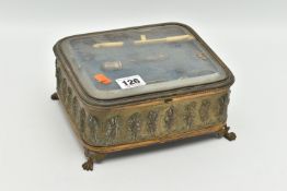 A FRENCH JEWELLERY CASKET, an embossed brass box with glass viewing panel to the hinged lid,
