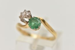 A DIAMOND AND EMERALD TWO STONE RING, an old cut diamond, approximate total diamond weight 0.65ct,