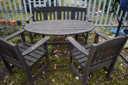 A WEATHERED STAINED TEAK PATIO SET, to include an oval table on trestle legs, length and height