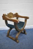 A 20TH CENTURY OAK SAVONAROLA CHAIR, the backrest with foliate carved detail and central shield