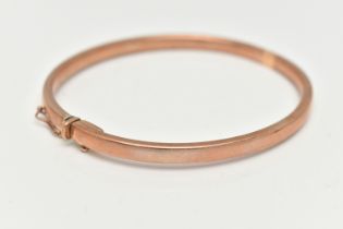 A ROSE METAL HINGED BANGLE, a solid hinged bangle, approximate width 4mm, fitted with an