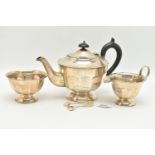 AN EDWARDIAN SILVER THREE PIECE TEA SET, faceted design, comprising of a teapot, fitted with an