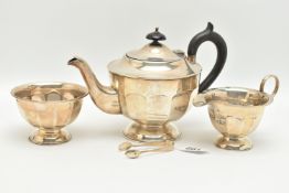 AN EDWARDIAN SILVER THREE PIECE TEA SET, faceted design, comprising of a teapot, fitted with an
