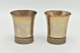 A PAIR OF ELIZABETH II SILVER BEAKERS, textured rims to the base, gilt exterior, hallmarked to the