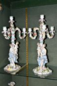 A PAIR OF CONTINENTAL FOUR FLAME FIGURAL CANDELABRA, depicting a woman and child beside the