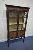 AN EDWARDIAN MAHOGANY DISPLAY CABINET, the double astragal glazed doors, enclosing two shelves, on