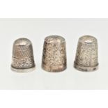 THREE THIMBLES, the first a silver thimble hallmarked 'Henry Griffith & Sons Ltd' Birmingham,