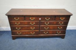 A REPRODUX MAHOGANY SIDEBOARD / CHEST OF DRAWERS, with canted corners, fitted with nine various