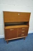 A MID CENTURY TEAK BUREAU, the fall front door enclosing a fitted interior, above three drawers