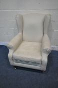 A CREAM LEATHER UPHOLSTERED WING BACK ARMCHAIR, width 82cm x depth 85cm x height 102cm (condition