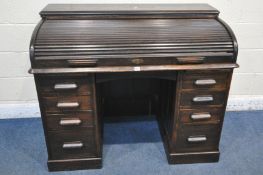 A 20TH CENTURY OAK ROLL TOP DESK, with a fitted interior, with an arrangement of nine drawers and