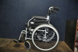AN ELITE CARE FOLDING WHEELCHAIR with two footrests and padded seat cushion