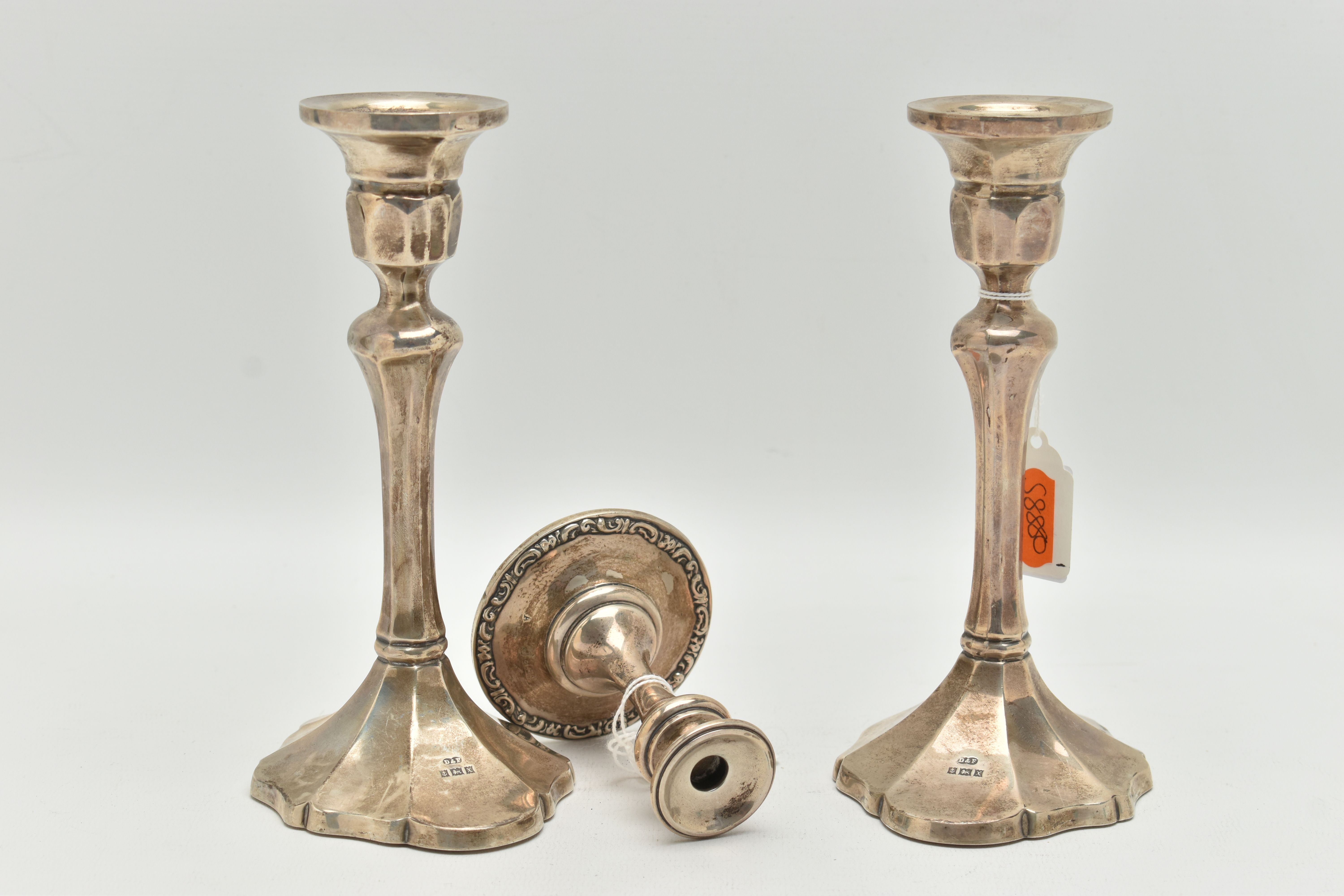 A PAIR OF ELIZABETH II SILVER CANDLESTICKS AND A DWARF CANDLE STICK, the first faceted pair of - Image 2 of 4