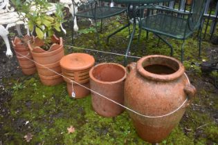 A TERRACOTTA URN SHAPED GARDEN PLANTER, height 51cm, along with two terracotta circular planters,