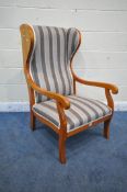 A WALNUT FRAMED WING BACK ARMCHAIR, with scrolled open armrests, with stripped upholstery, width