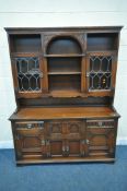 A 20TH CENTURY OAK OLD CHARM DRESSER, the top fitted with two lead glazed doors and an arrangement