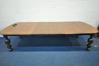 A LATE 19TH / EARLY 20TH CENTURY OAK WIND OUT DINING TABLE, with rounded ends, two additional