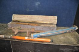A VINTAGE LEG VICE, A WOODEN CASED PIPE THREADING STOCK, another stock (all very rusty and may