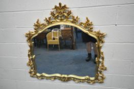 A GILT RESIN WALL MIRROR, with a flamboyant open foliate frame, 122cm x 116cm (condition report: