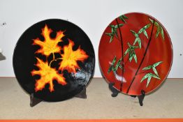 TWO MODERN POOLE POTTERY CHARGERS, comprising an 'Autumn Leaves' charger, diameter 40.5cm and a