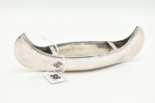 A VICTORIAN SILVER CANNOE ORNAMENT, designed as a Victorian love boat, approximate length 180mm,